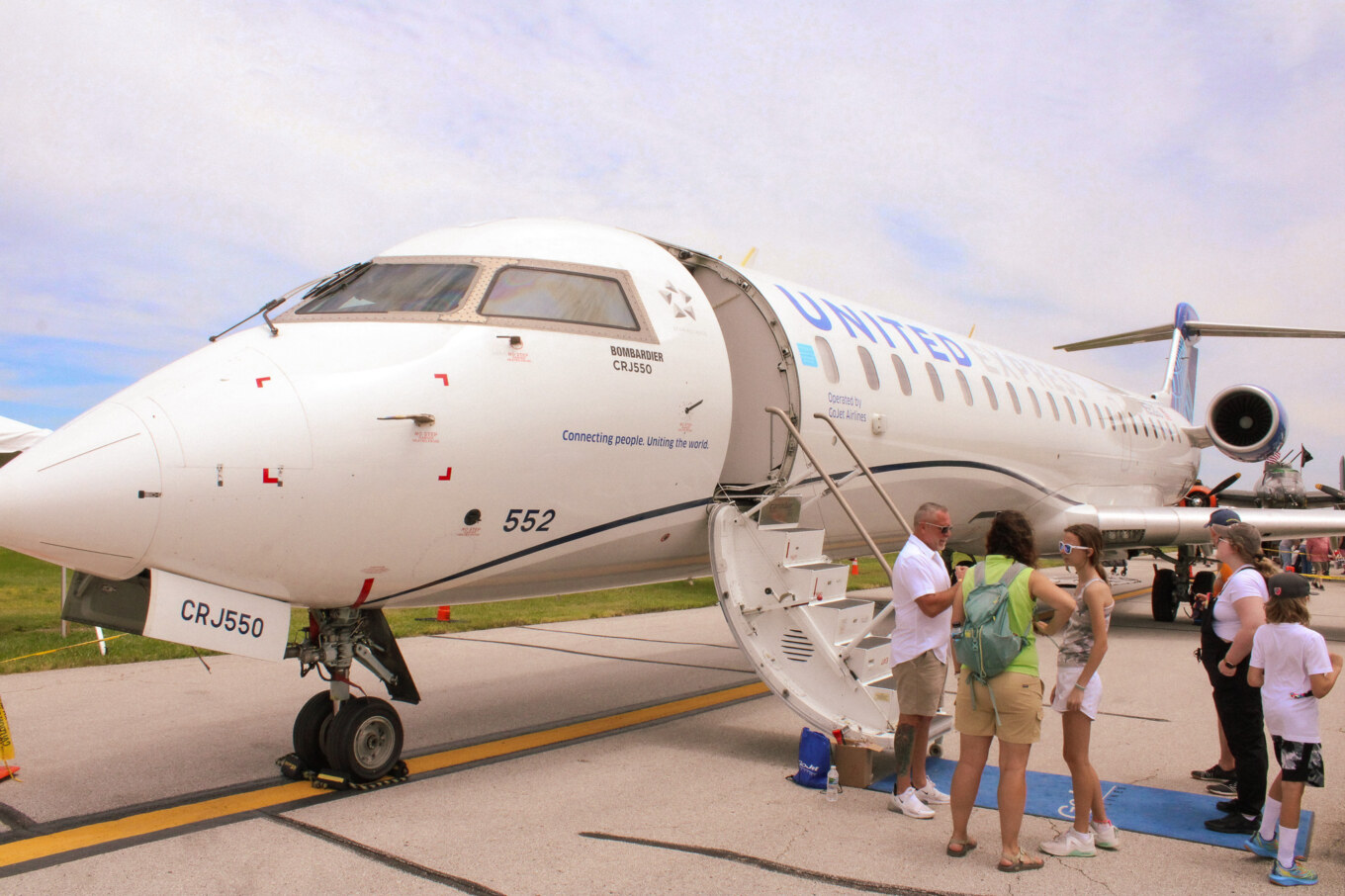 People standing in line outside CRJ-550