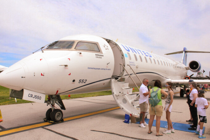 People standing in line outside CRJ-550