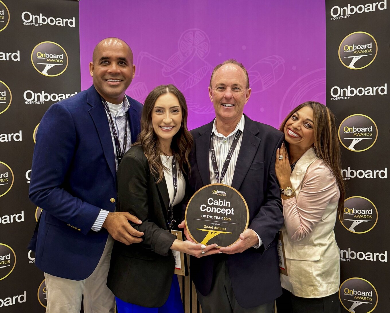 Group smiling and looking at camera with award